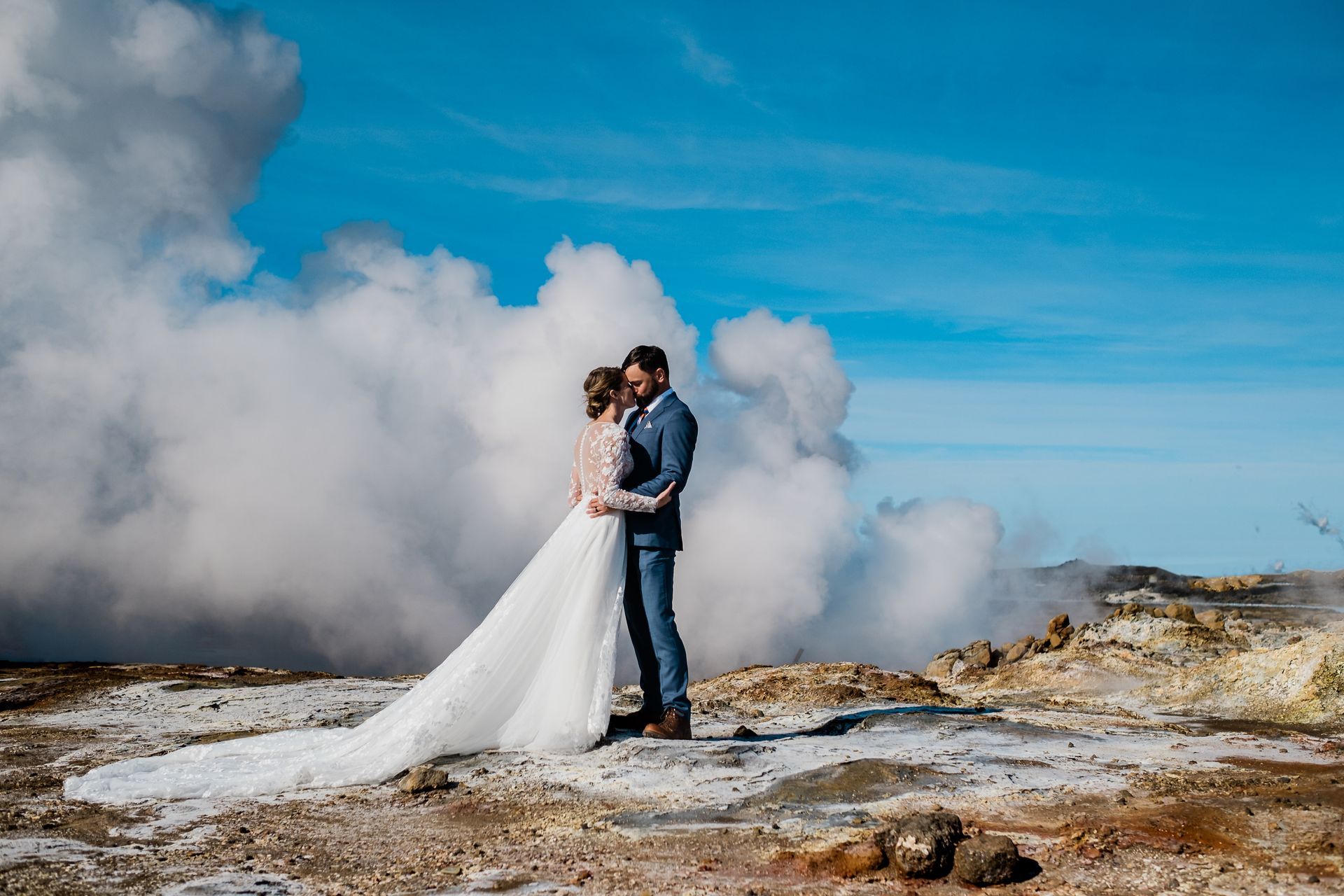 Stunning couple standing and hugging at Gunnuhver during their ethereal Summer Elopement in Iceland