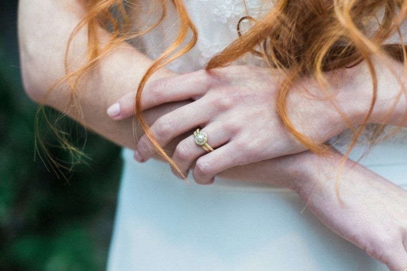A close up of a woman 's hand with a ring on it.