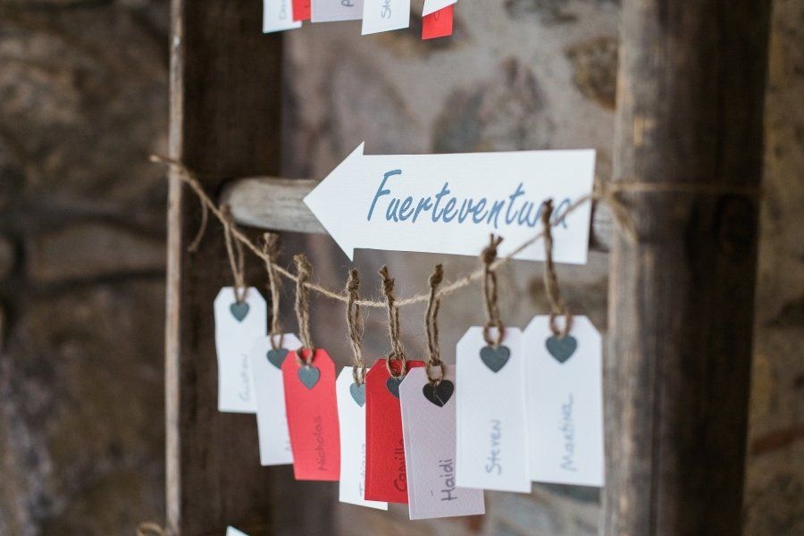 A wooden ladder with seating cards and a sign that says fuerteventa
