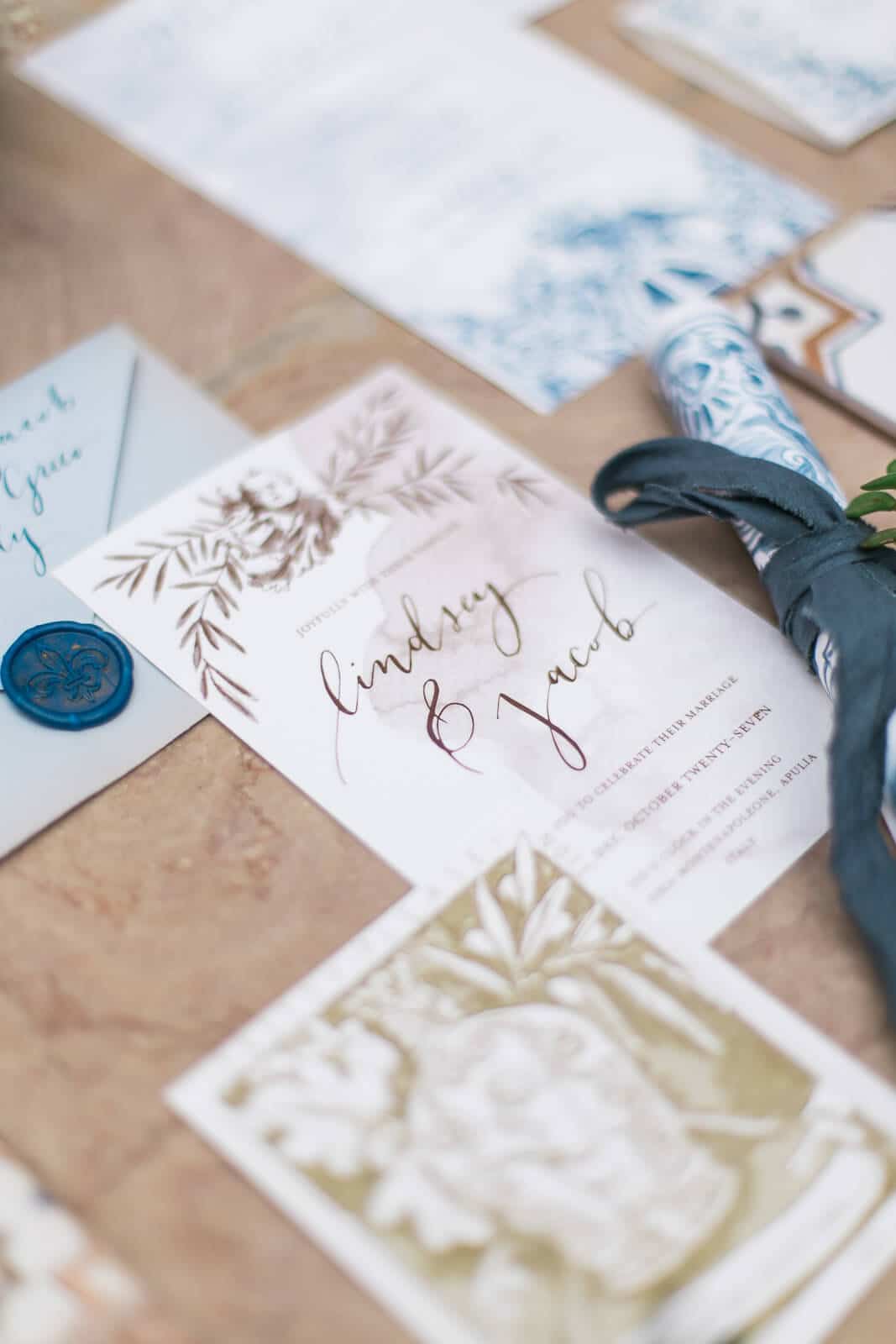 A close up of a wedding invitation and envelope on a table.