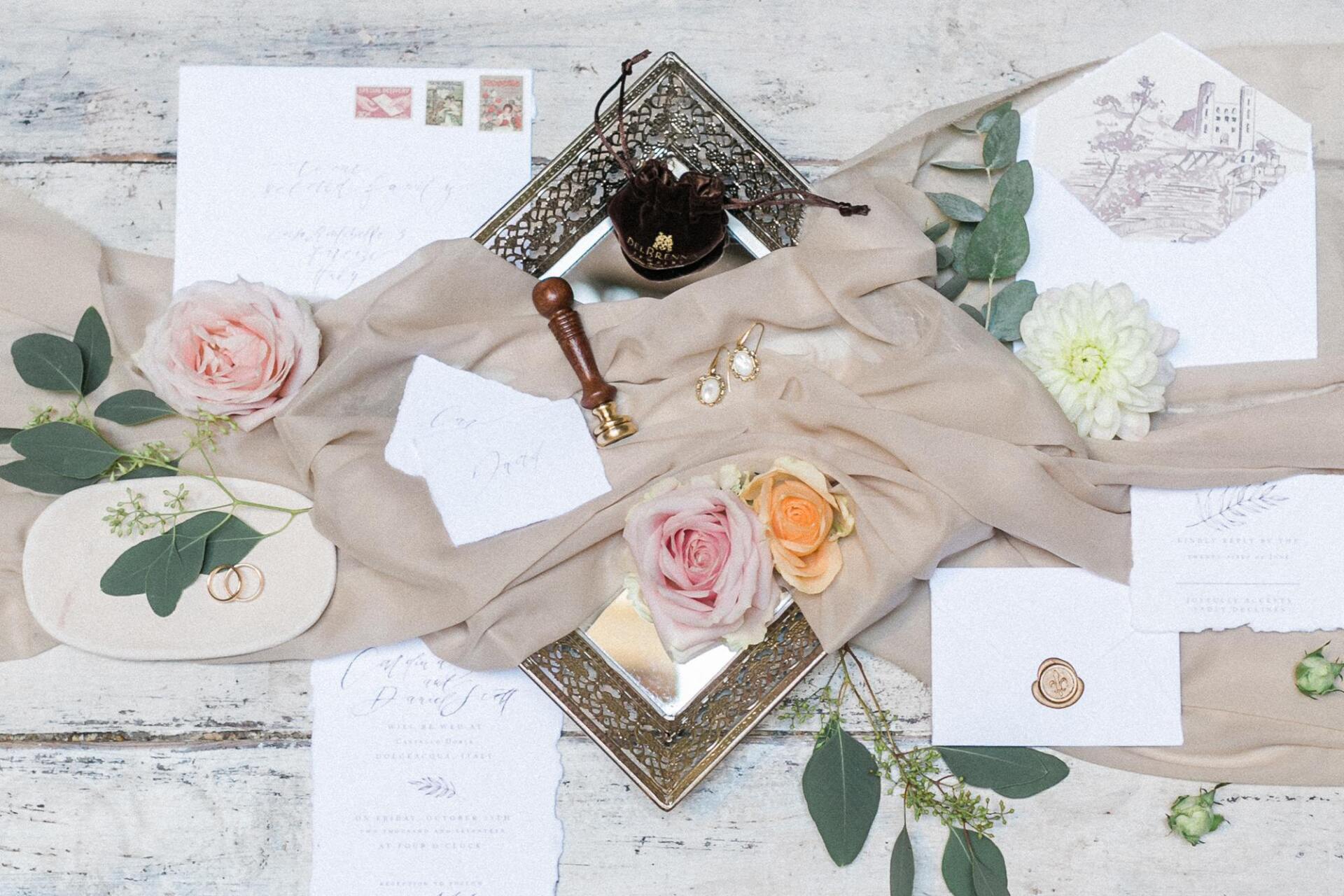 A table with a lot of papers and flowers on it