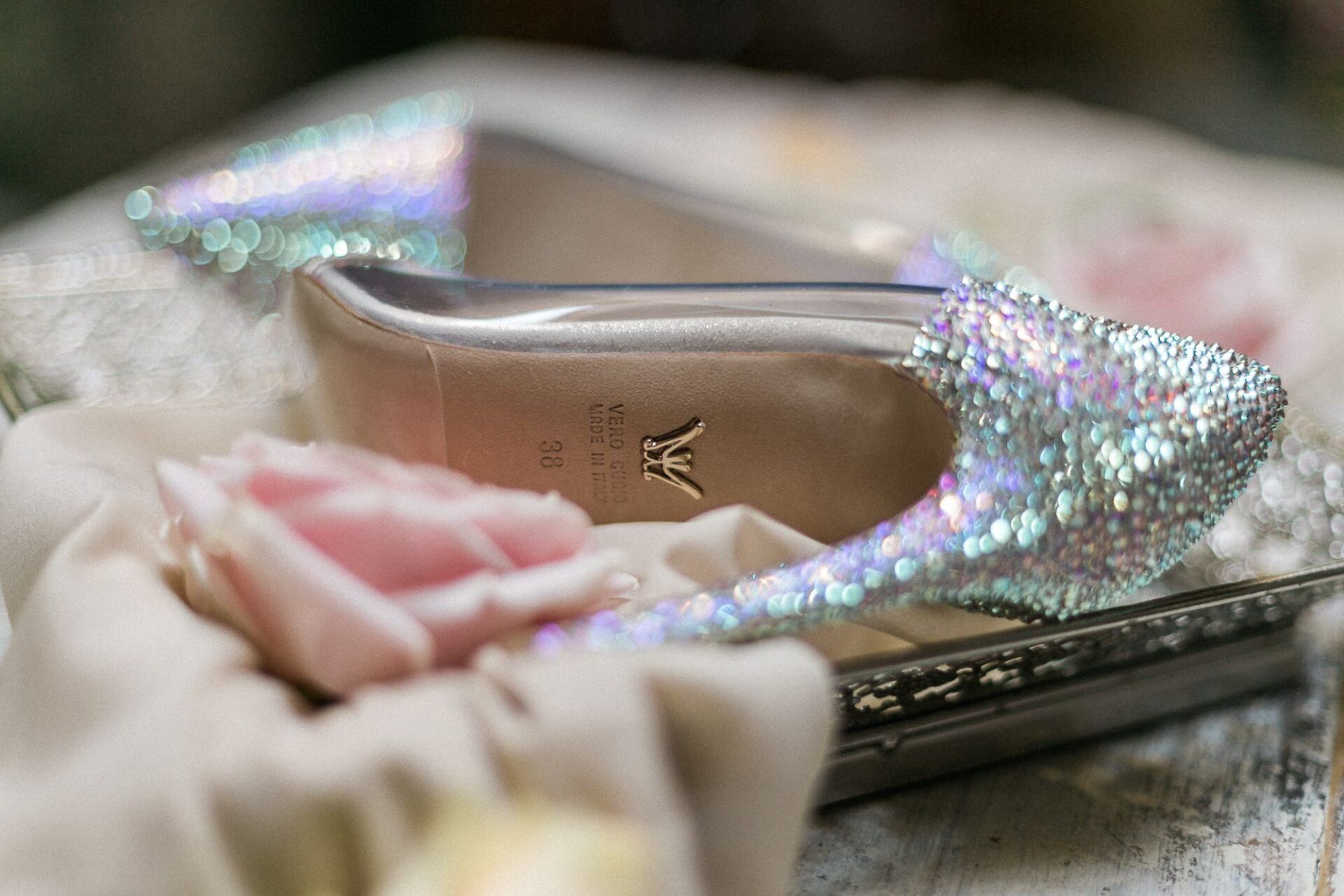 A pair of shoes sitting on top of a clutch on a table.