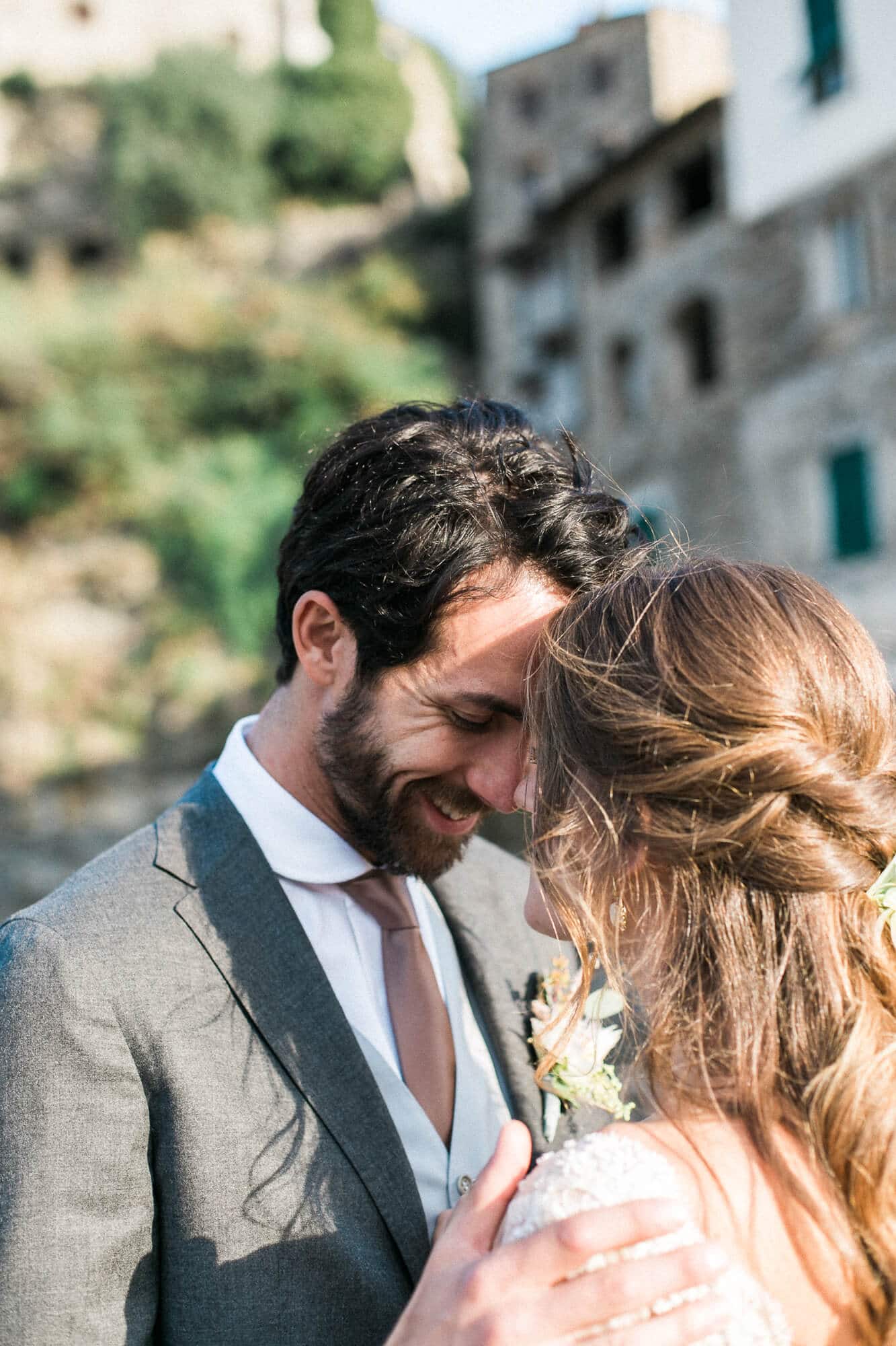 A bride and groom are looking into each other 's eyes on their wedding day.