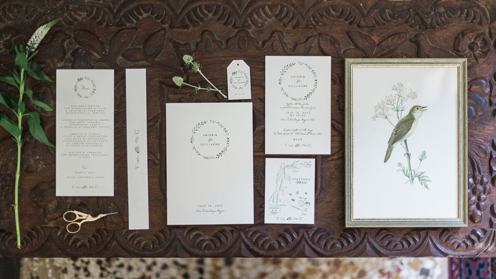 A bunch of cards and a picture of a bird on a table.