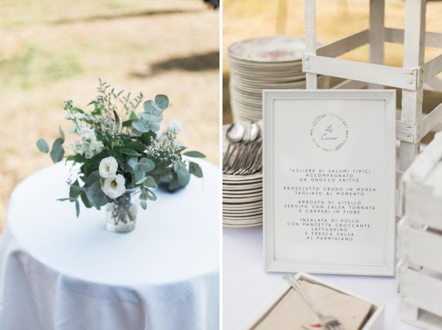 A table with a vase of flowers and a menu on it.
