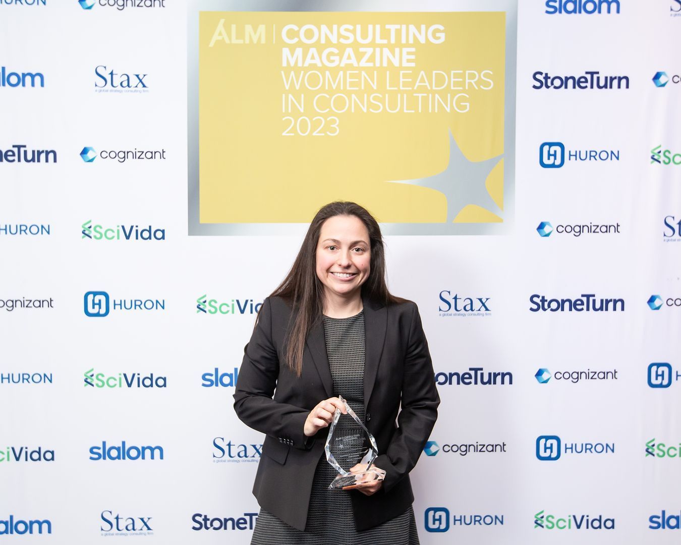 Image of Kelsey Chisholm with the Consulting Magazine’s 2023 Women Leaders in Consulting Award.