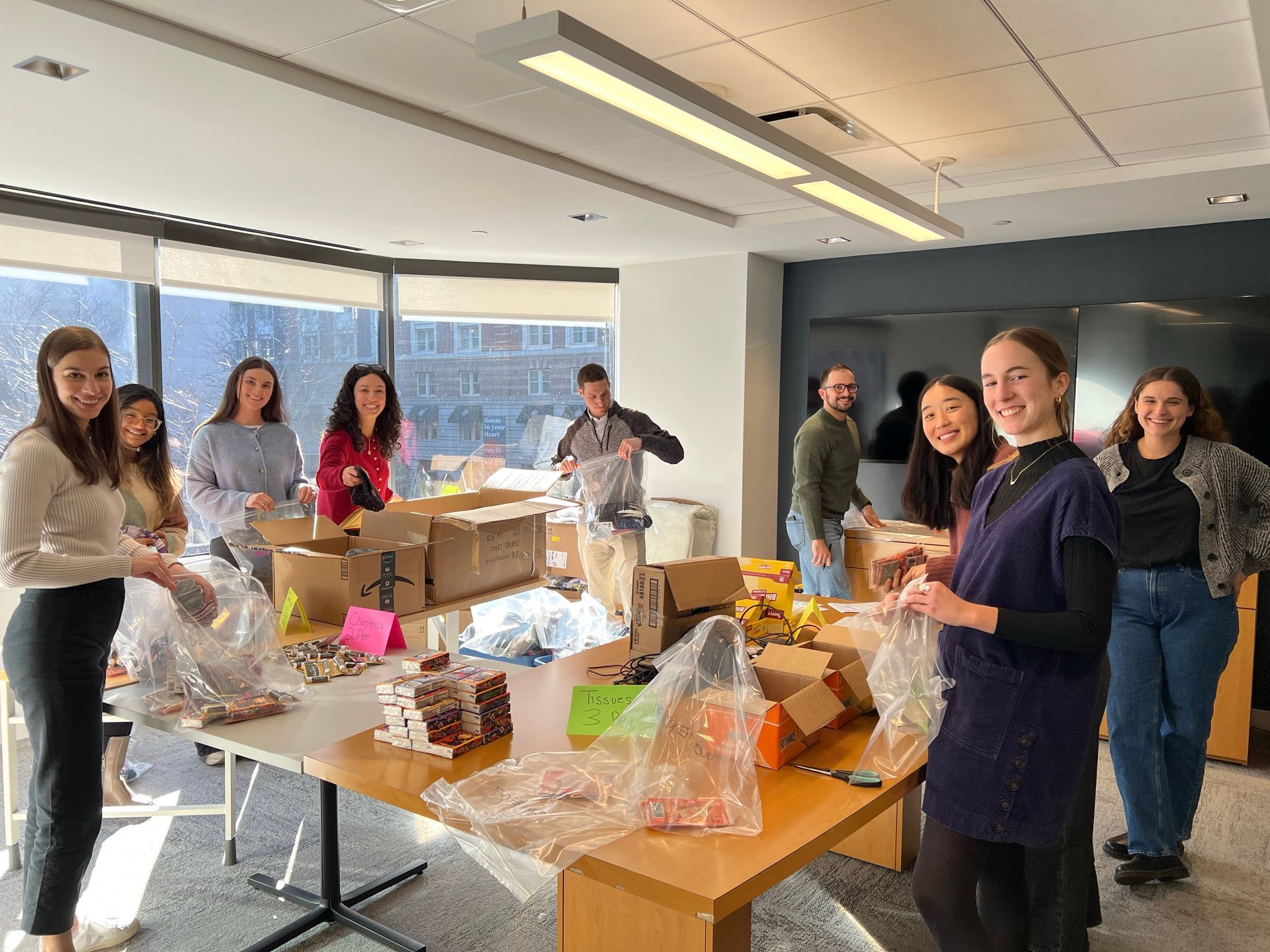 Group photo of Staxers assembling kits