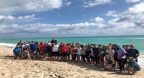 Fellow Staxxers gather on Miami Beach for a group shot during our 2020 offsite.