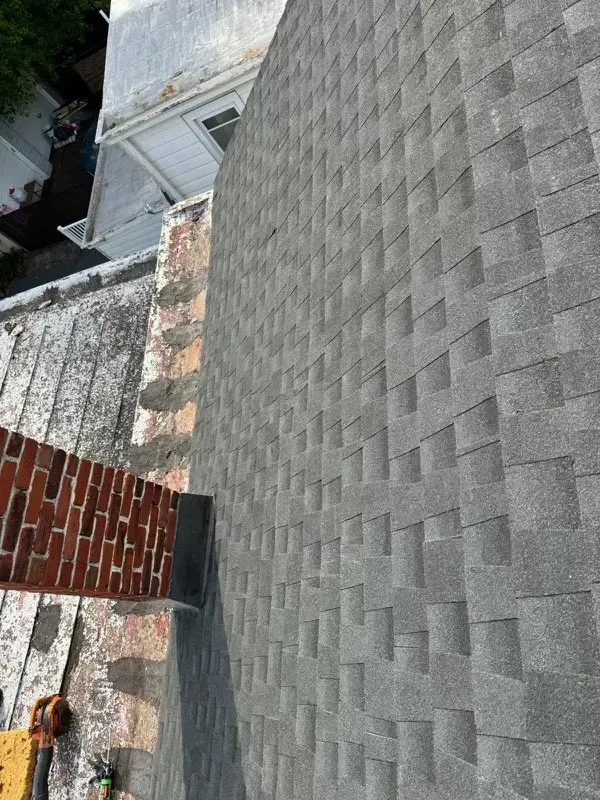 A roof with a brick chimney on top of it.