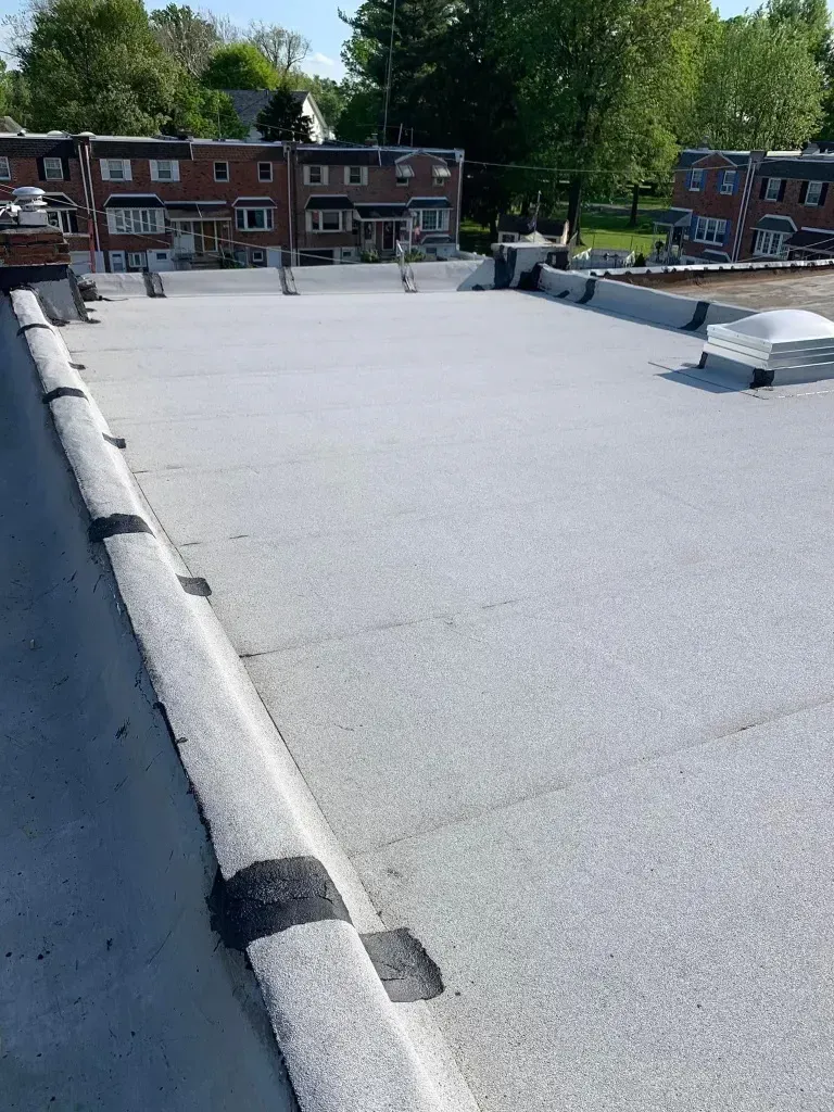 A roof with a gray roof and a lot of buildings in the background