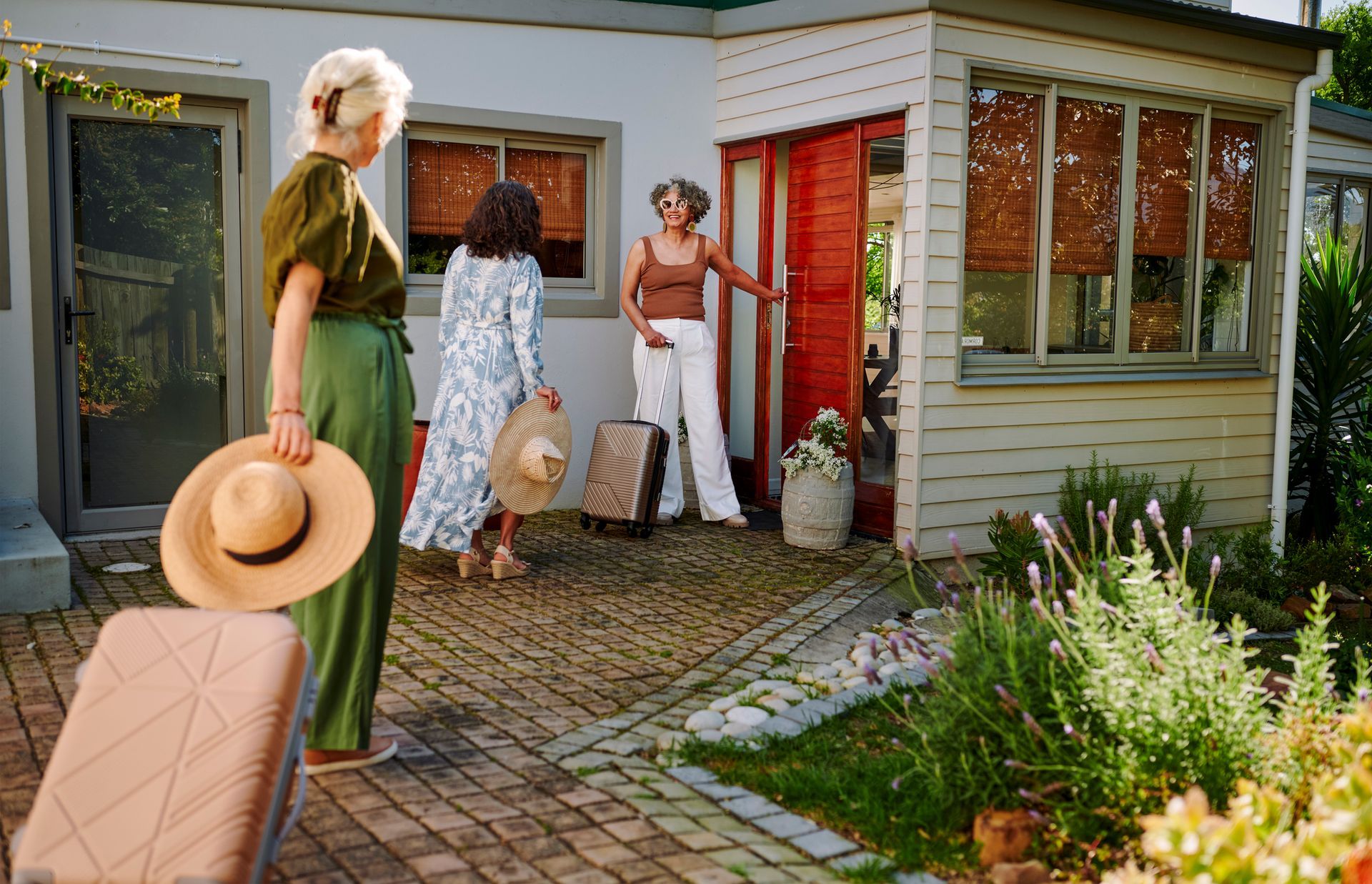 A brick house under construction with a man on a ladder.
