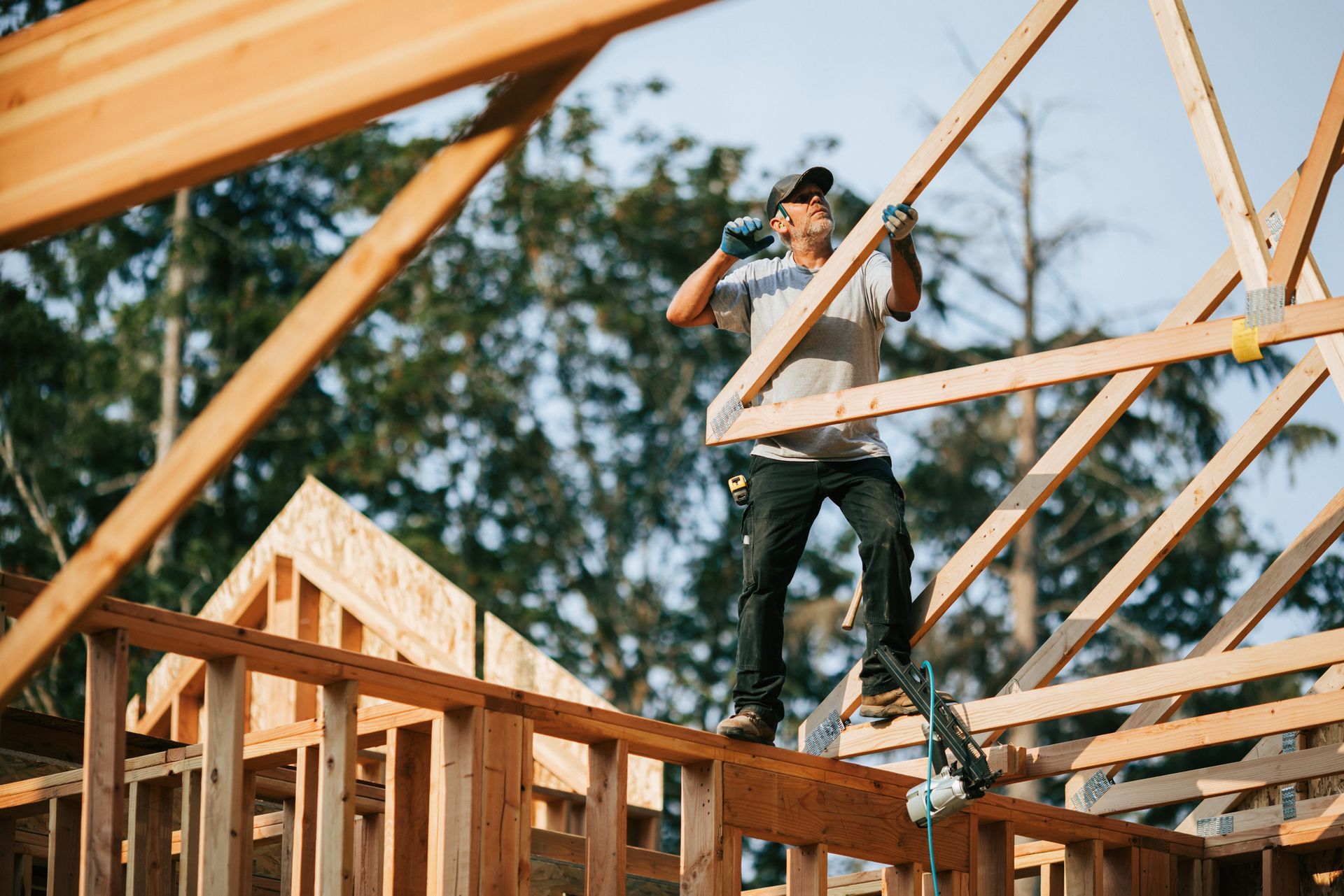 A man is standing on top of a wooden structure.