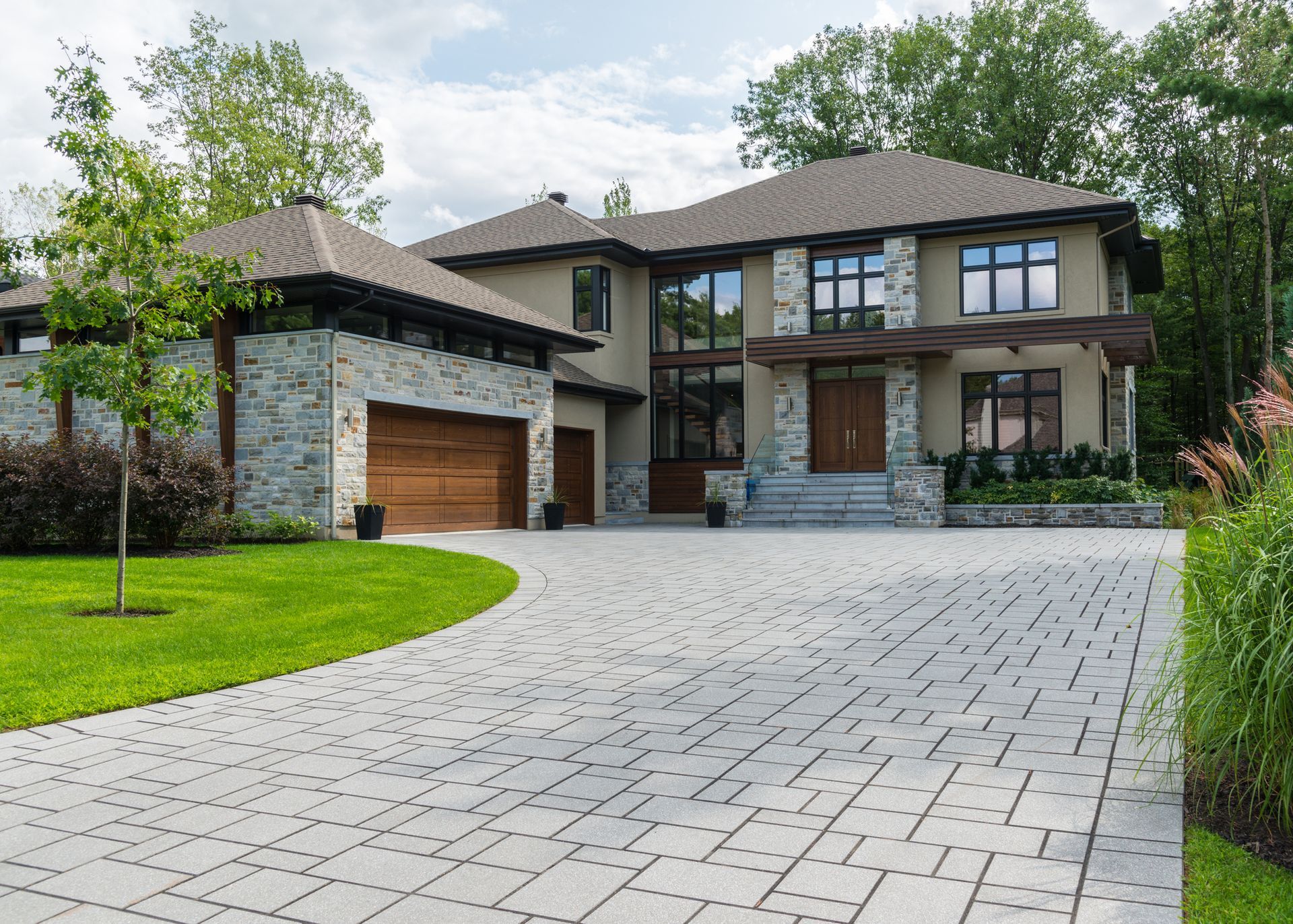 A large house with a large driveway leading to it.