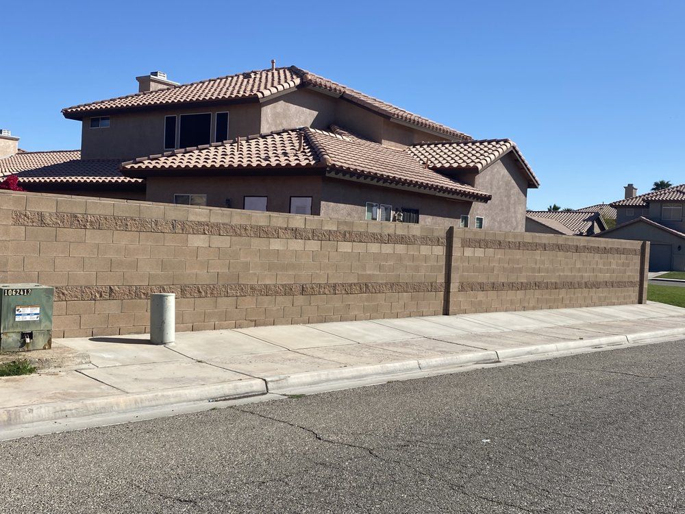 A man is standing in front of a house under construction.