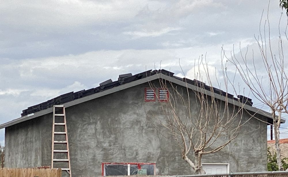 A large house is being built in a residential area.