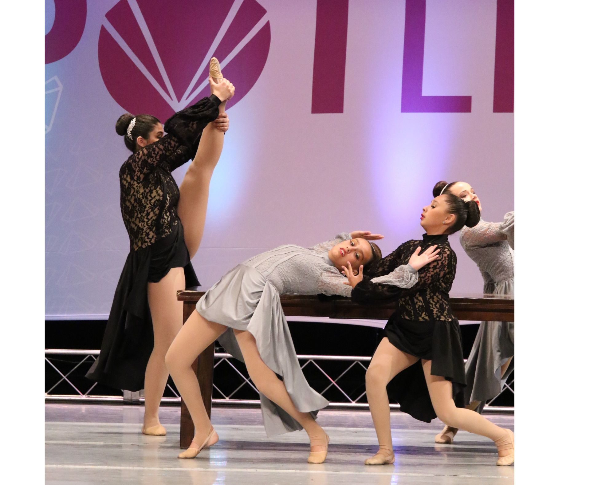 A group of young women are performing a dance on stage
