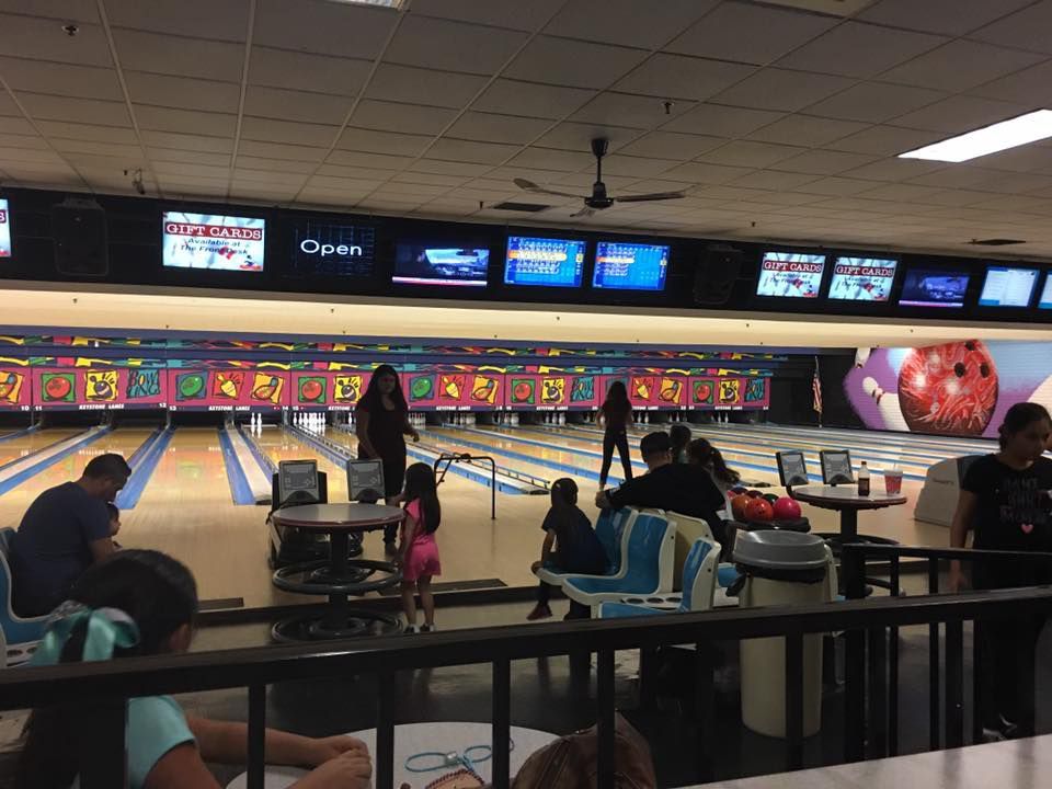 A group of people are playing bowling in a bowling alley.