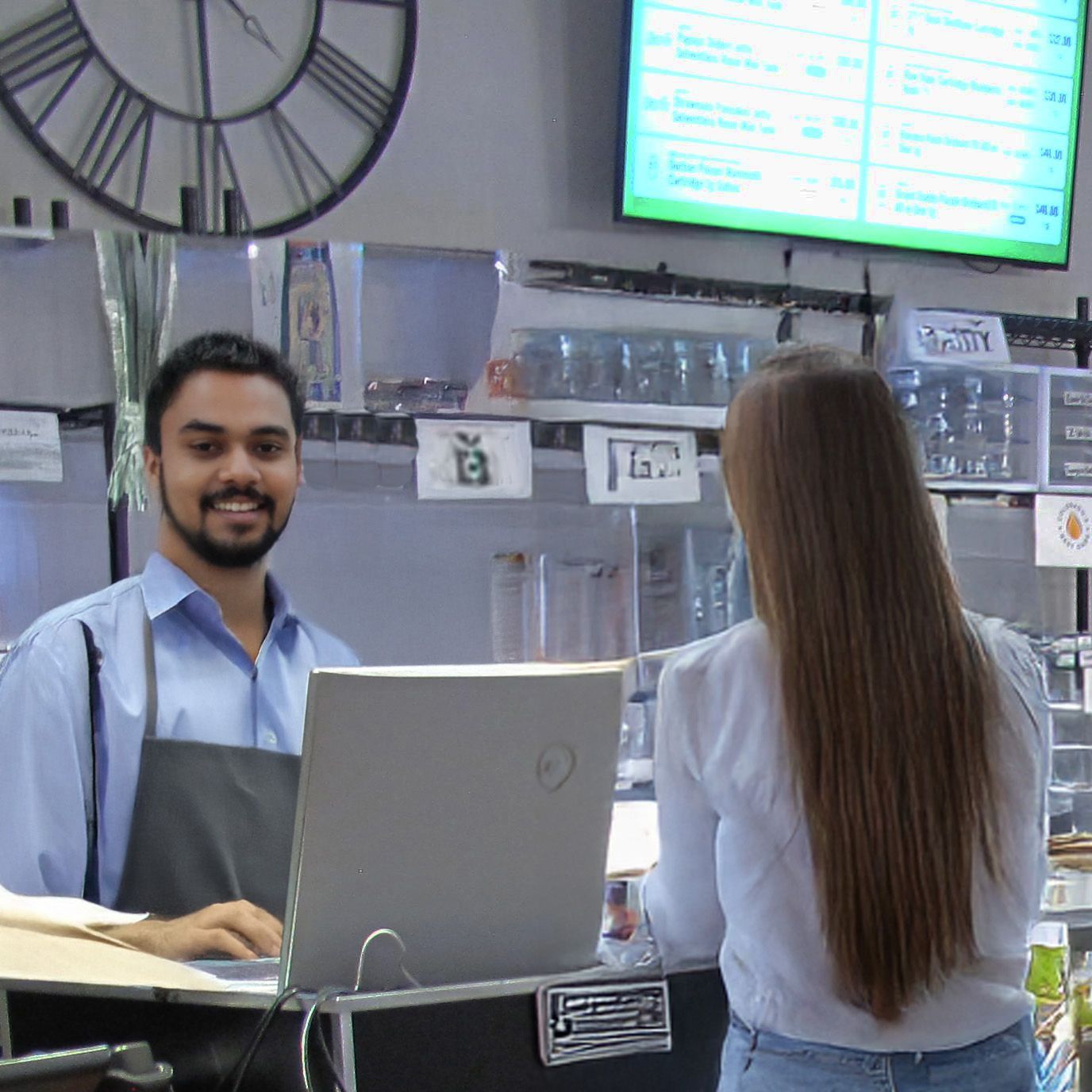 Customer care - Canna Care staff assisting a customer at the register - Dispensary Open Near Me