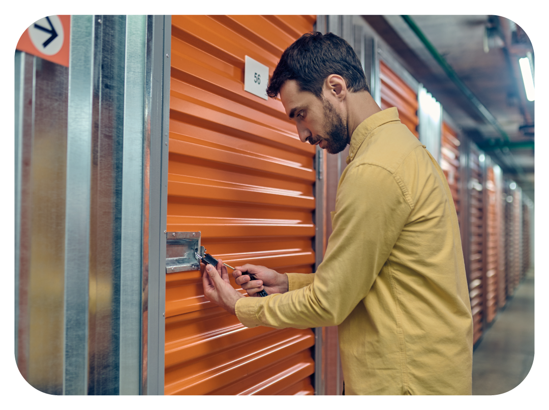 Close-up of a combination lock and a hand locking a storage unit with a padlock.