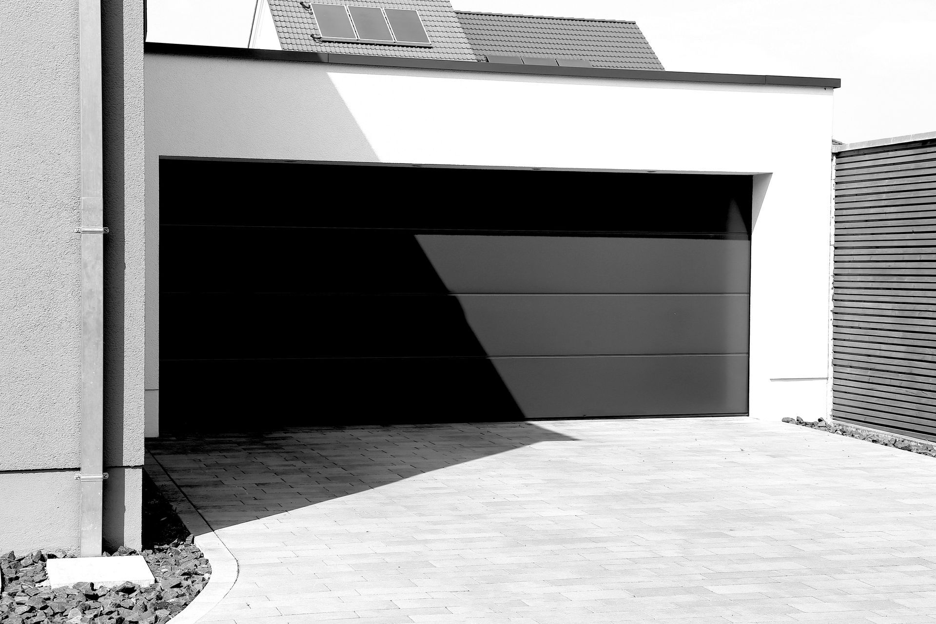 A black and white photo of a garage door
