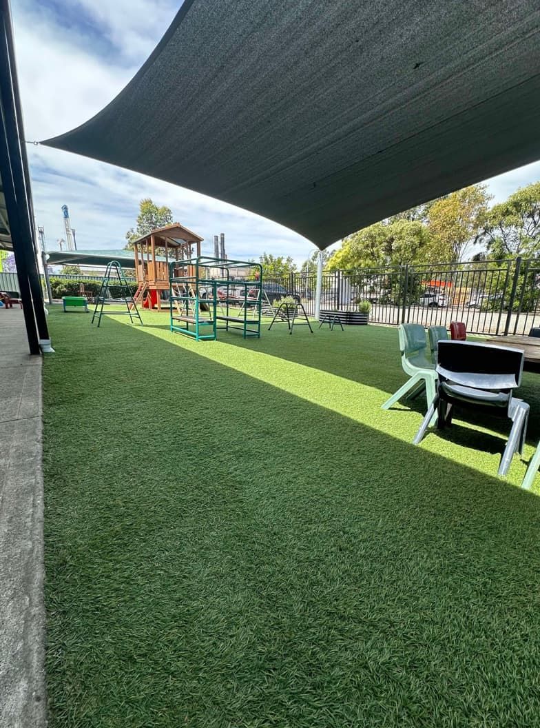 A Playground With Tables And Chairs Under A Canopy — Gibbo’s Lawns & Property Maintenance In Salamander Bay, NSW