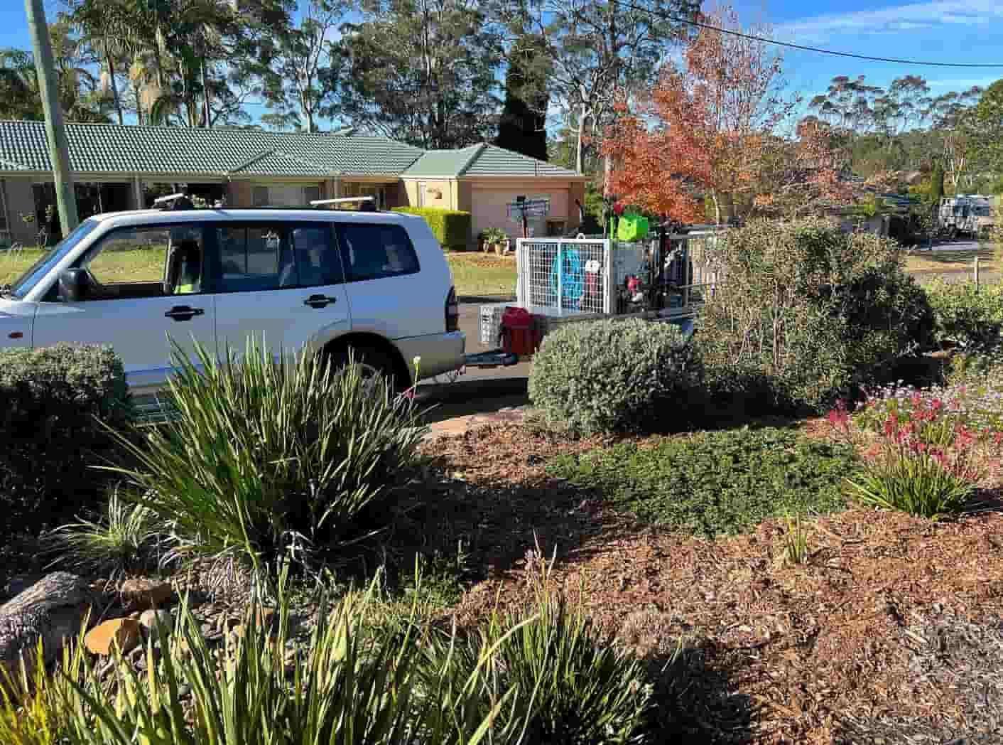 A White Van Is Parked In Front Of A House In A Garden — Gibbo’s Lawns & Property Maintenance In Medowie, NSW