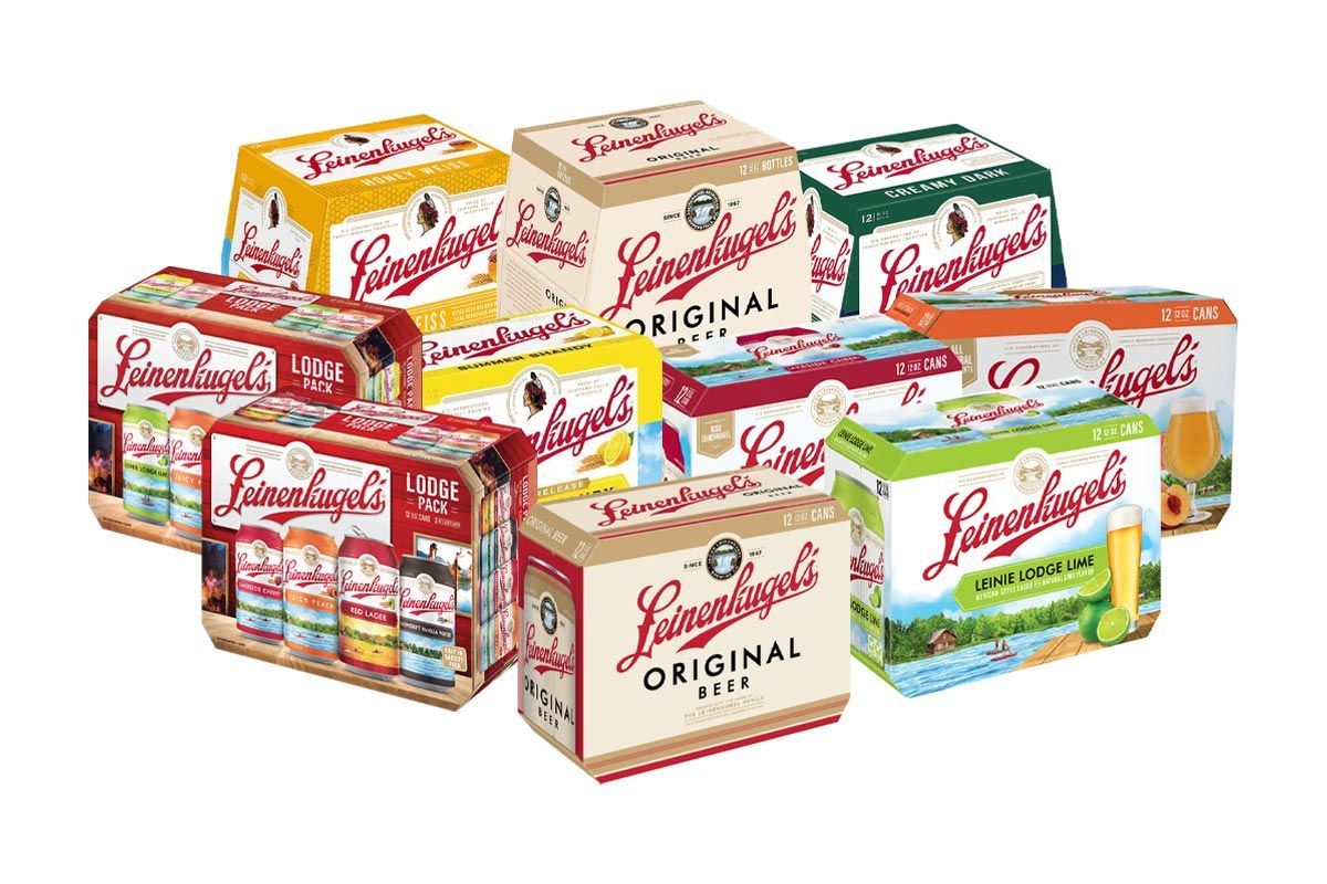 A bunch of boxes of beer are stacked on top of each other on a white background.
