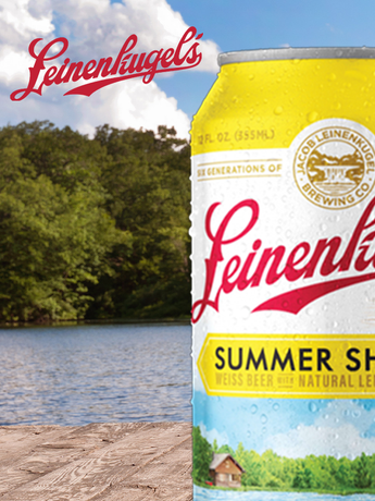 A can of leinenkugel 's beer with a lake in the background