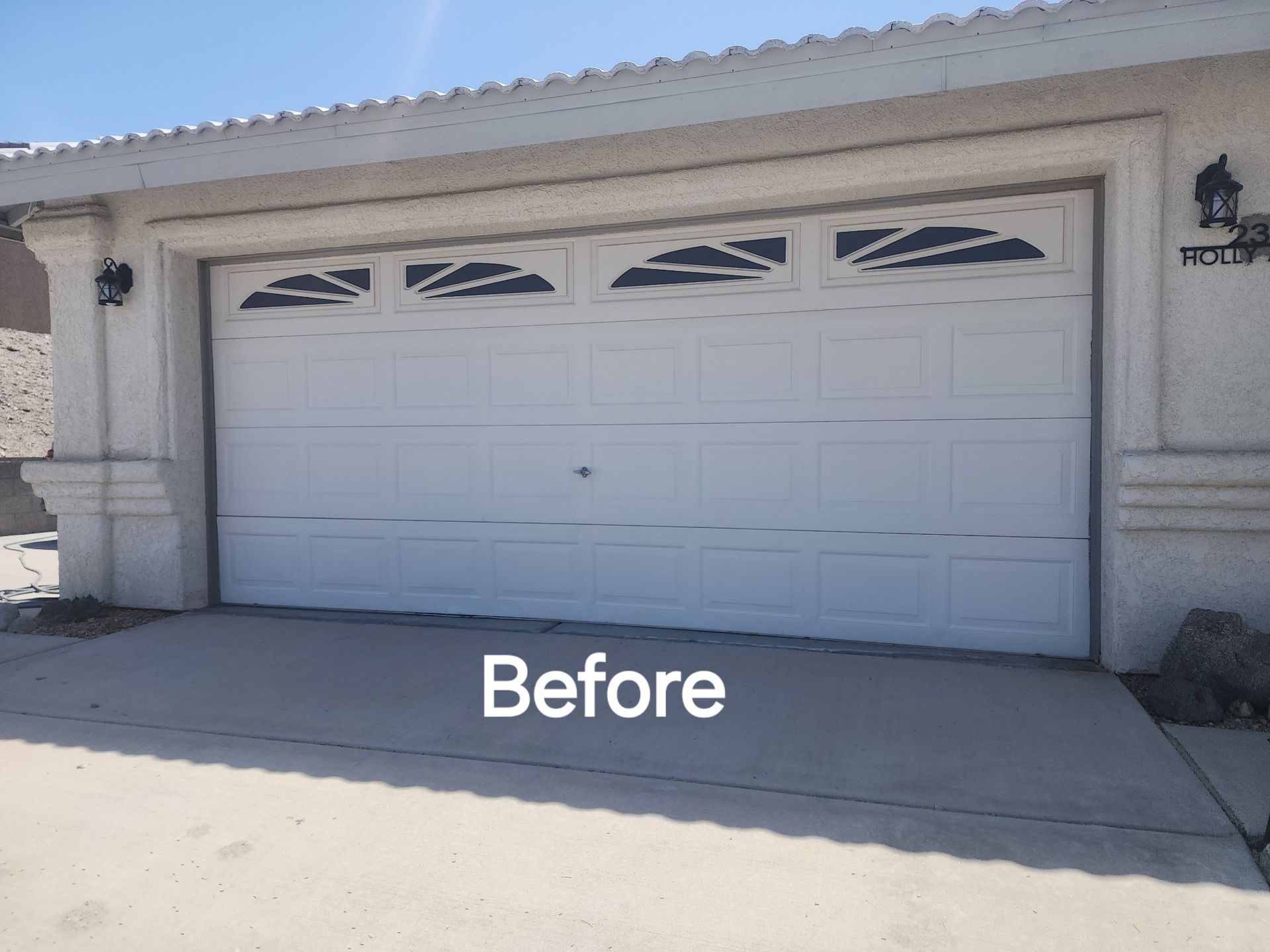 A before picture of a white garage door