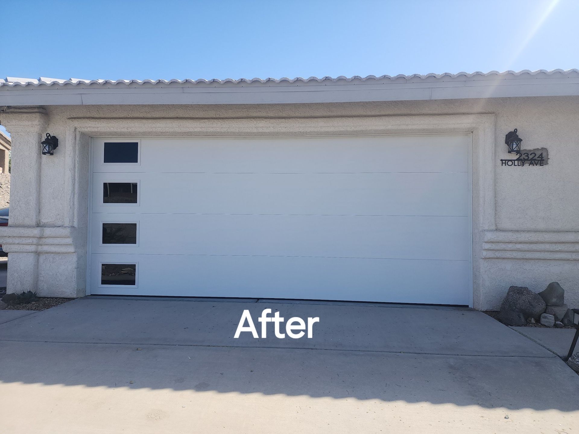 A picture of a garage door after being painted white