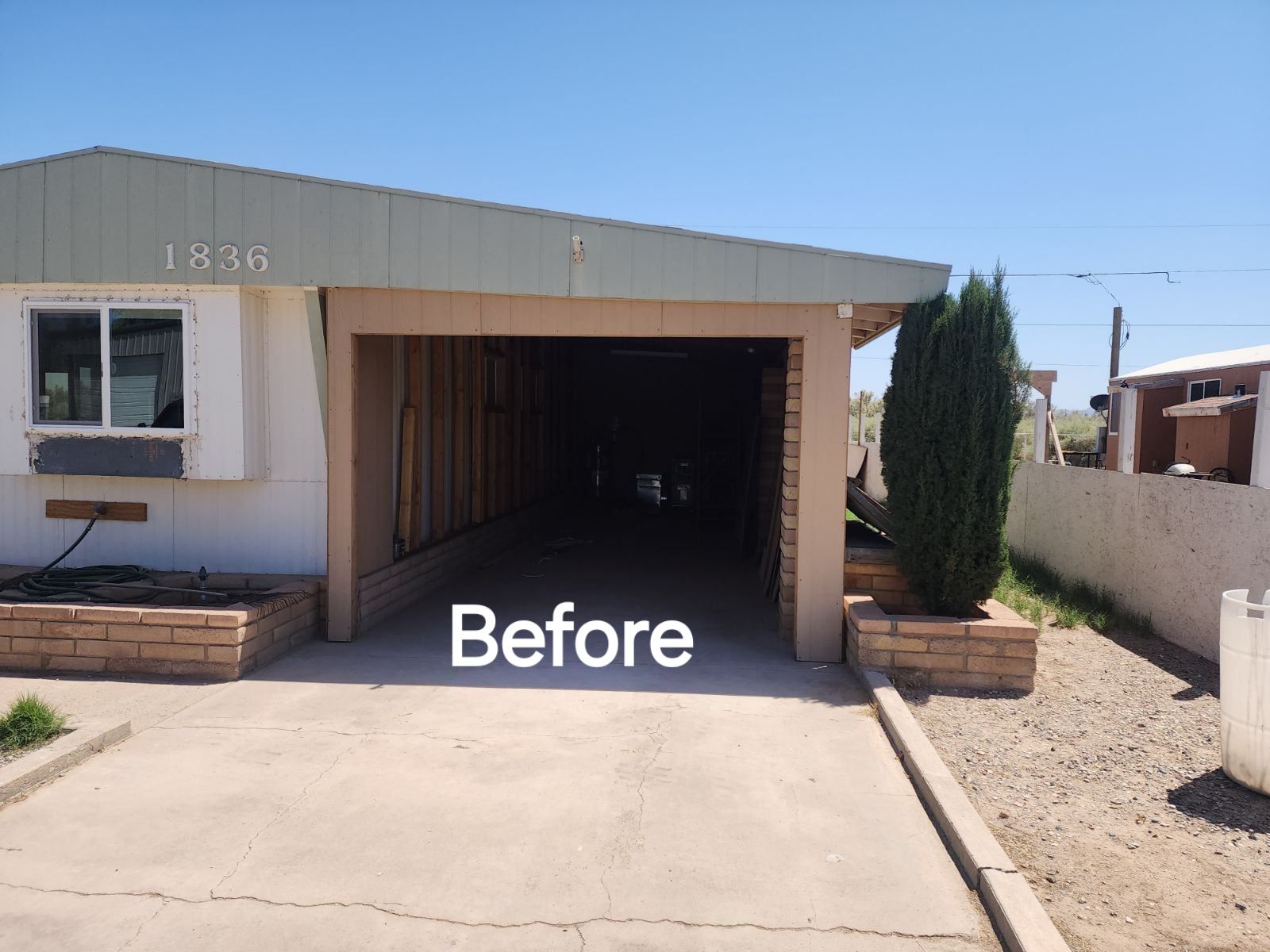 A before picture of a mobile home with a garage