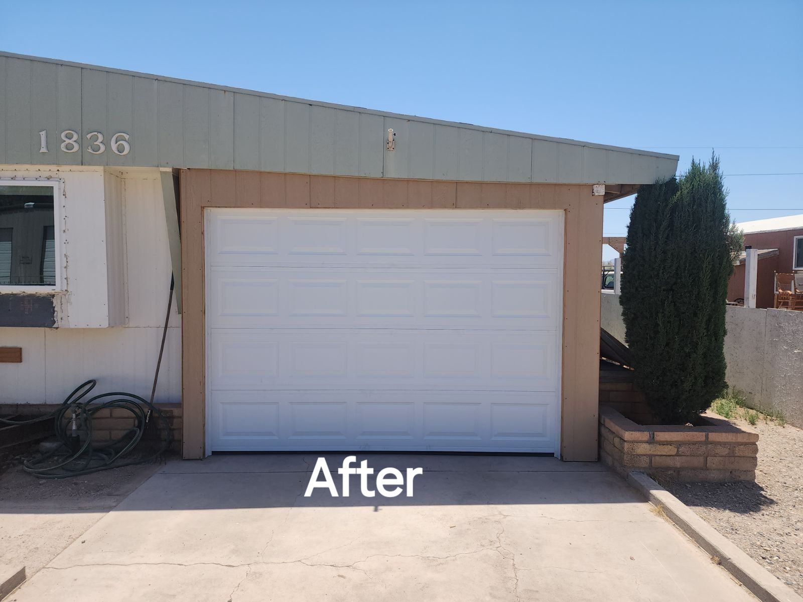 A picture of a garage door after being painted white