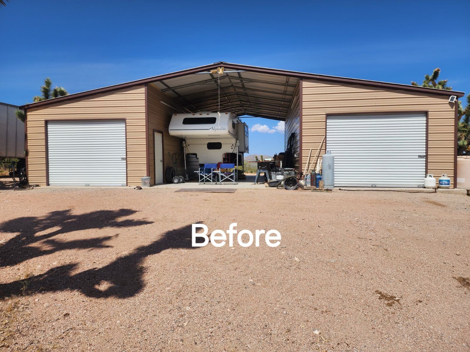 A before picture of a garage with a trailer in it