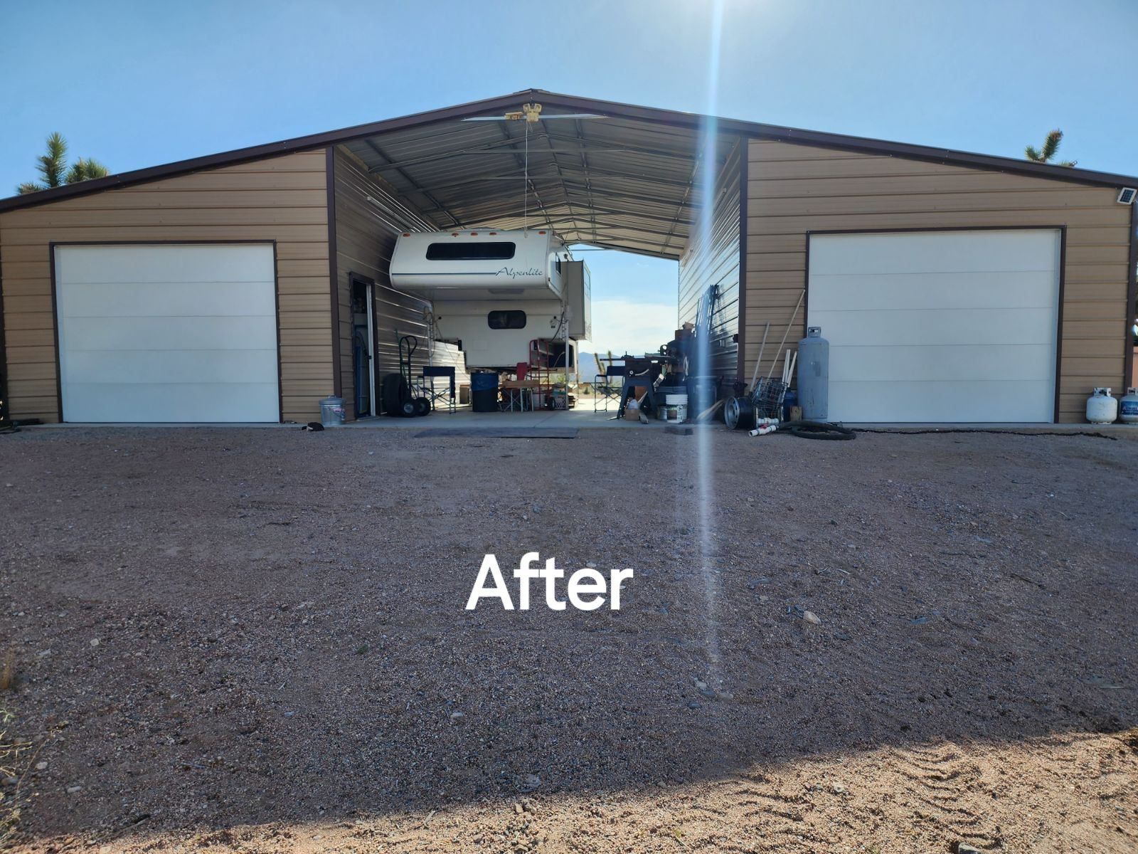 A picture of a garage with a trailer inside of it.