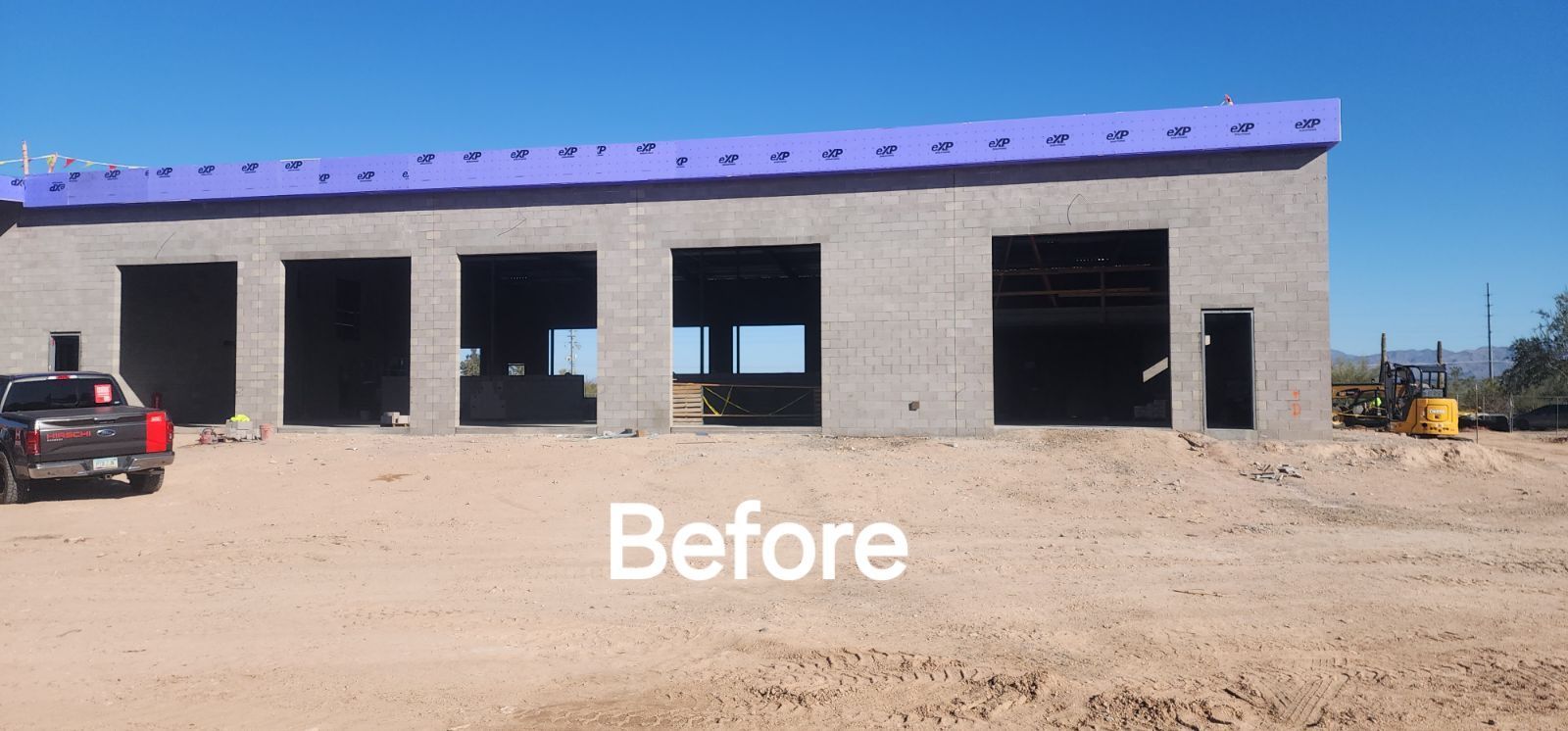 A truck is parked in front of a building that is under construction.