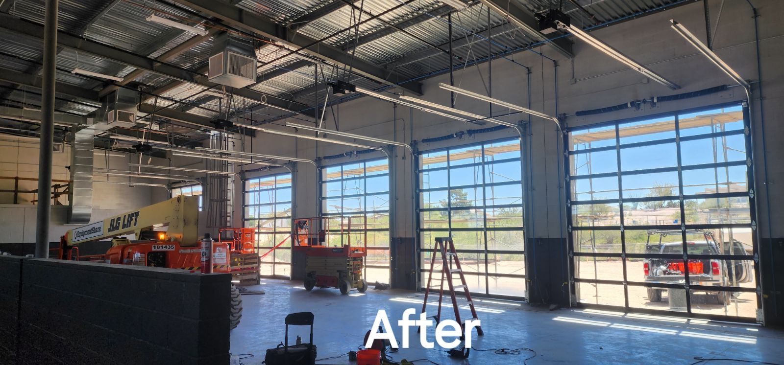 A large garage with a lot of windows and a lot of lights.