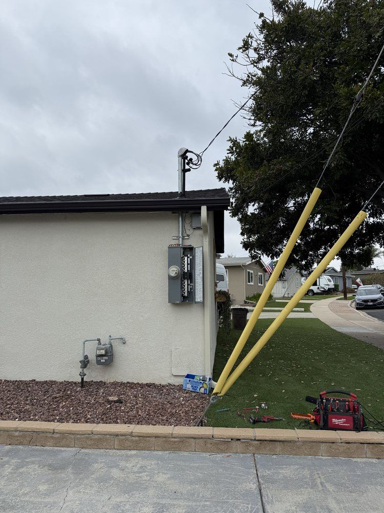 A white house with a yellow pole in front of it
