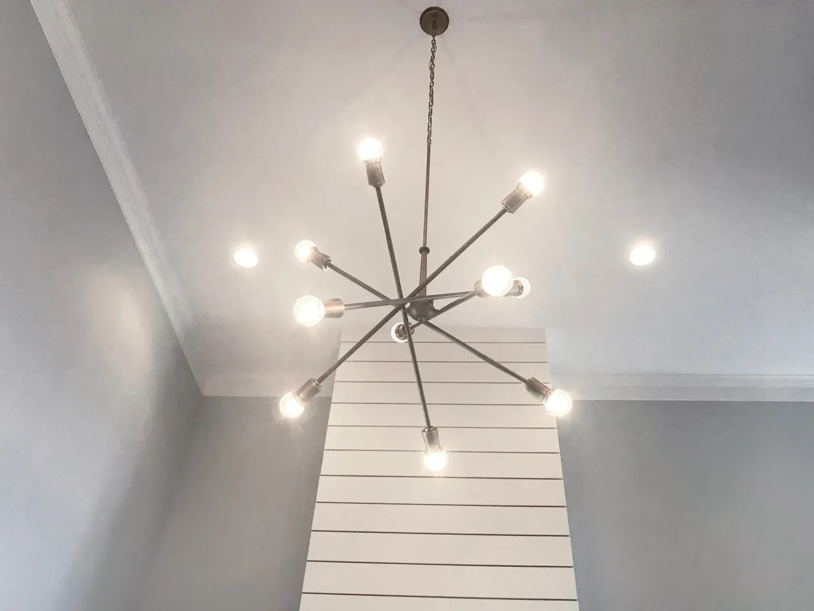 A chandelier is hanging from the ceiling in a room.