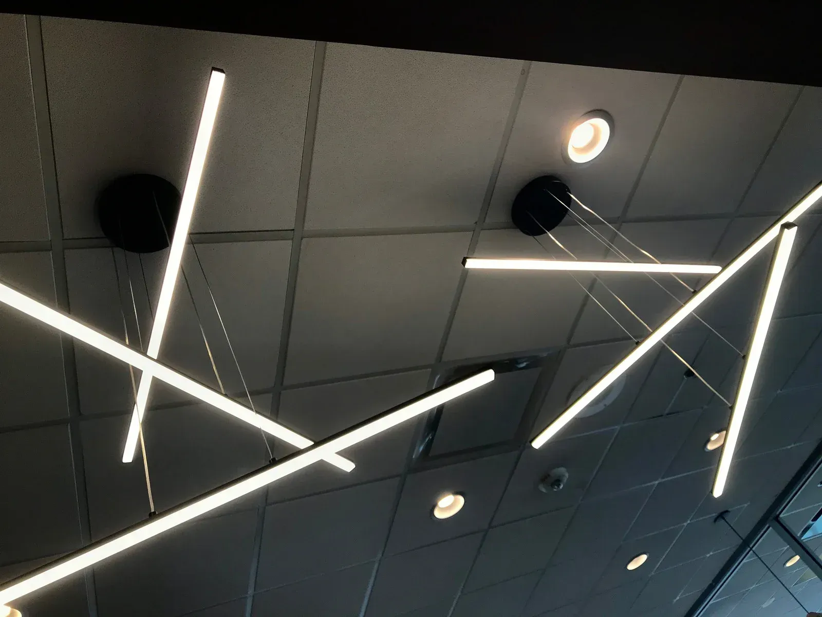 A ceiling with a lot of lights hanging from it