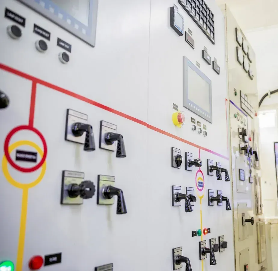 A wall with a lot of switches and buttons on it