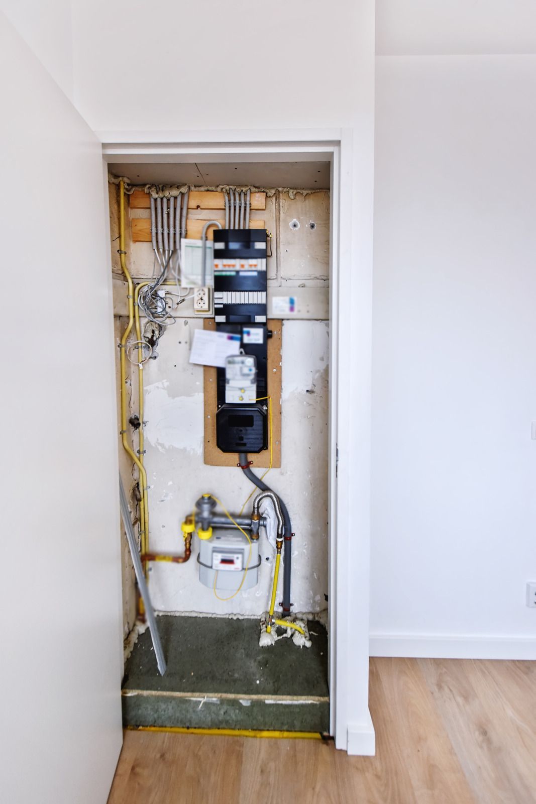 A room with a lot of electrical wires hanging from the wall.