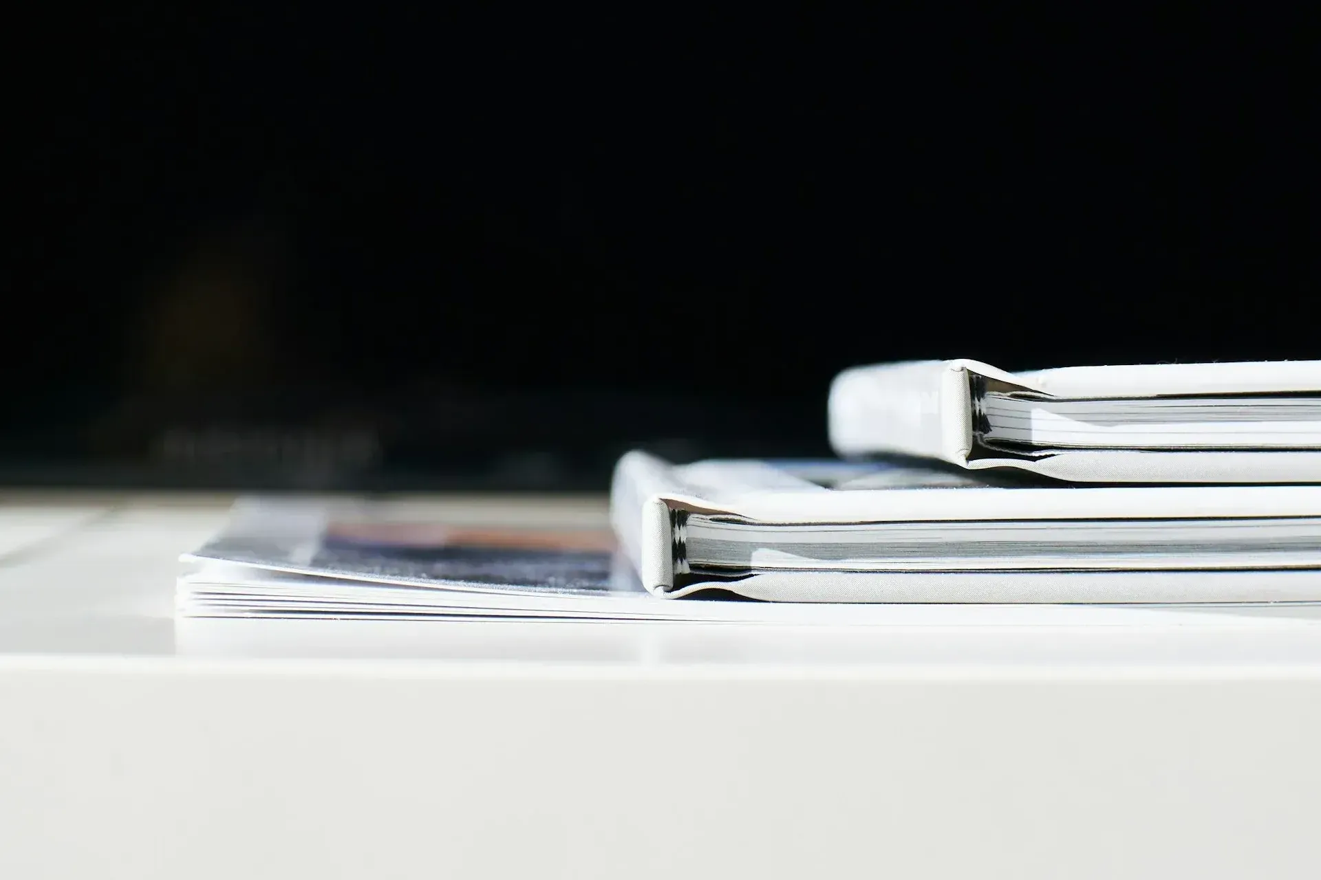 A stack of binders sitting on top of each other on a table.
