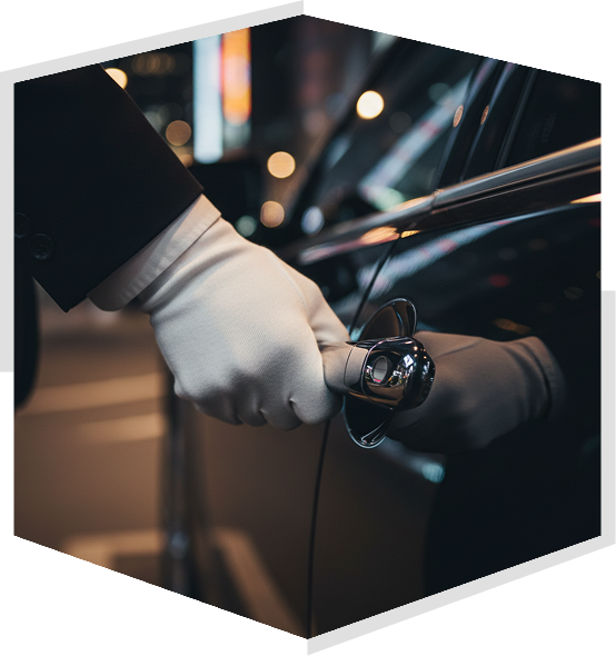 Man loading luggage into car trunk for woman. Outside modern building.