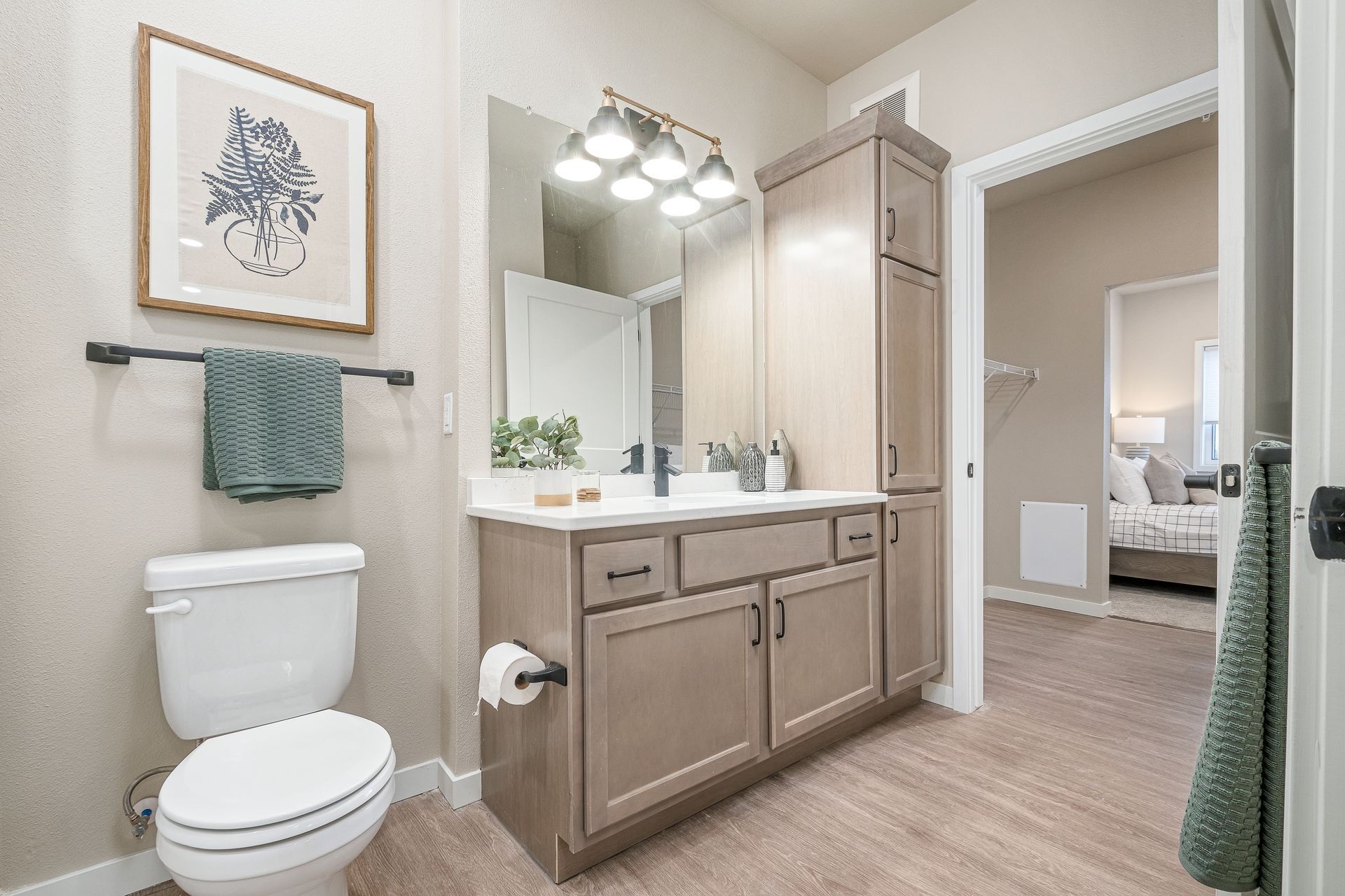 A bathroom with a toilet , sink and mirror.