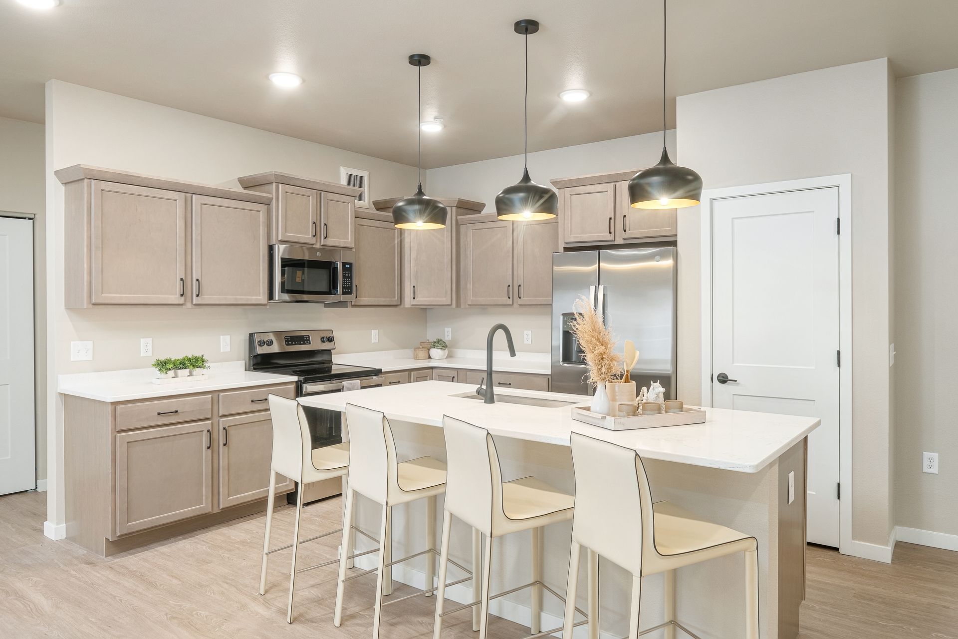 A kitchen with stainless steel appliances and a large island.