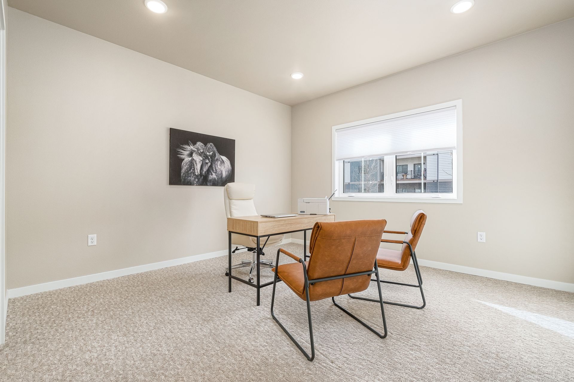 There is a desk and chairs in the room.