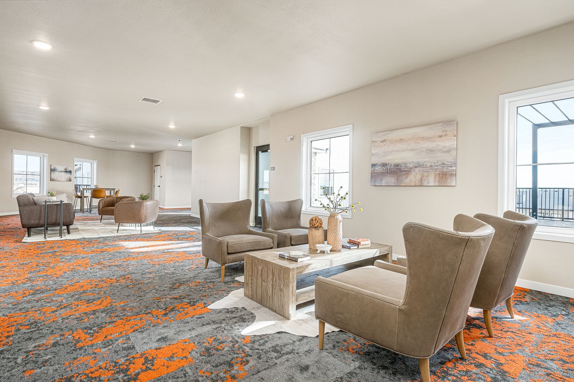 A living room filled with furniture and a rug.