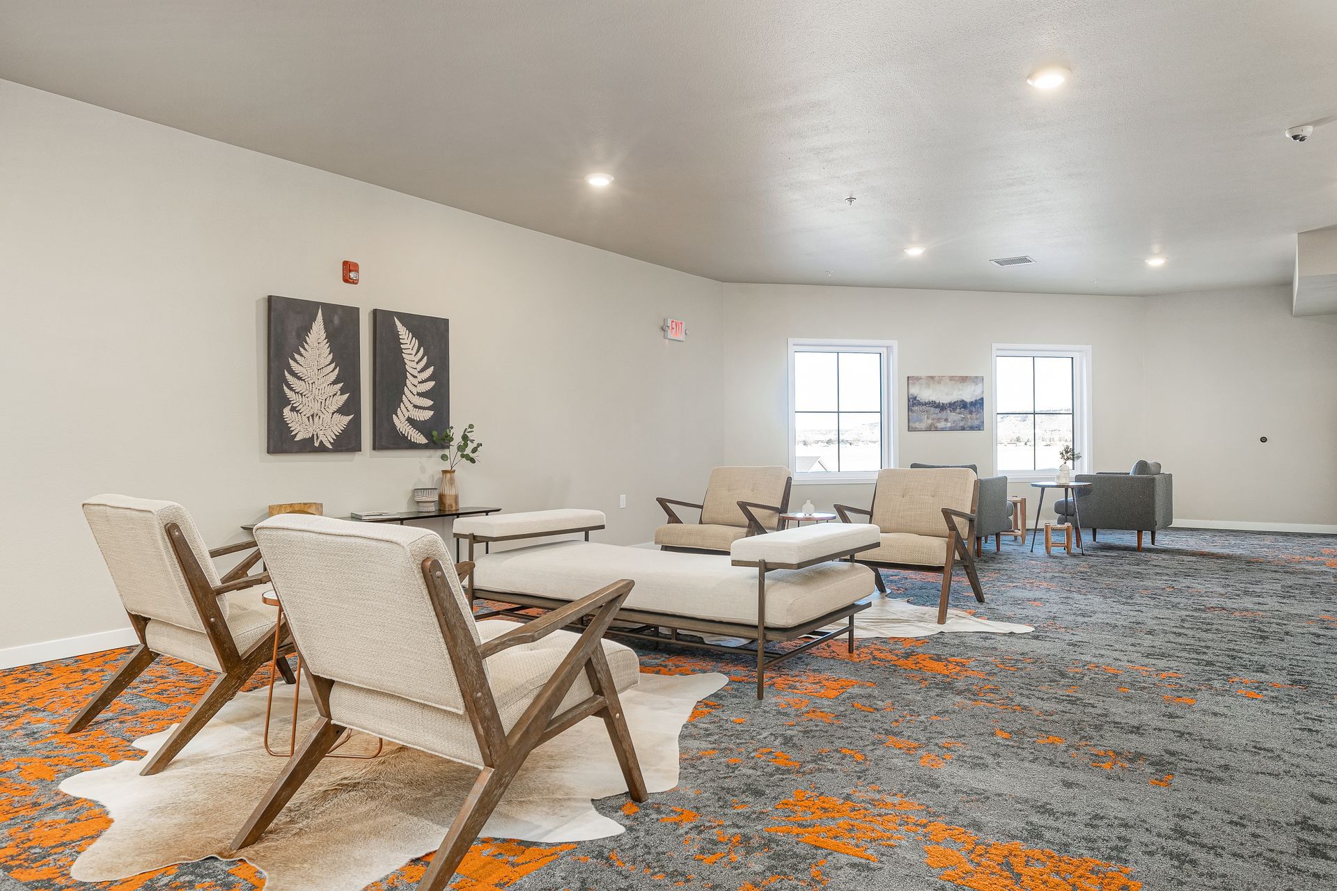 A living room filled with furniture and a rug.
