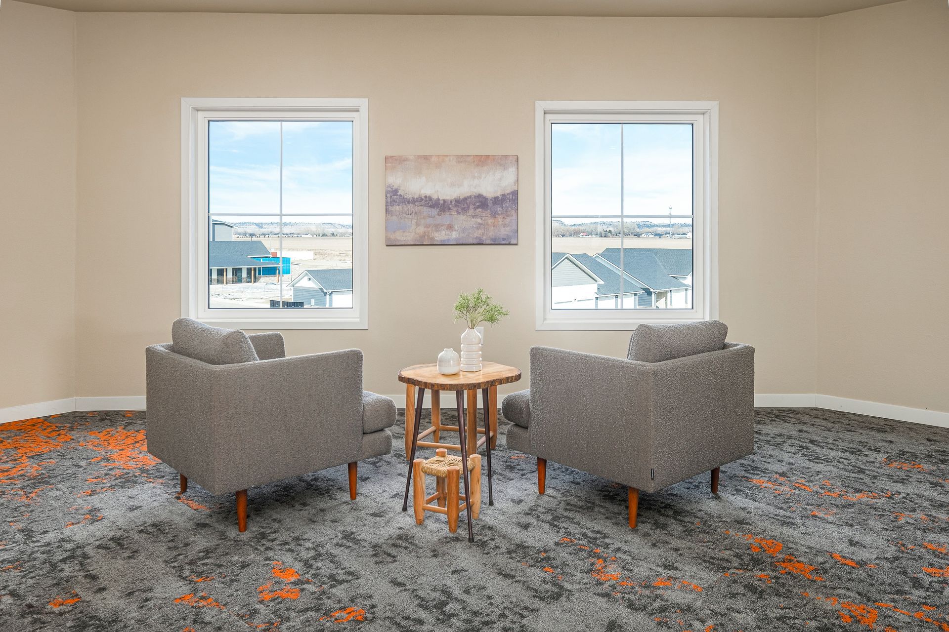 There are two chairs and a table in the room.