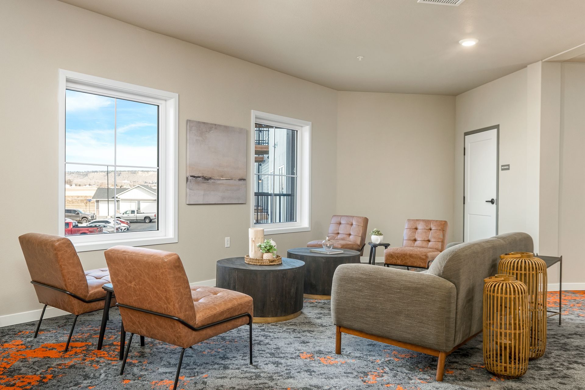 A living room with a couch , chairs , and a table.